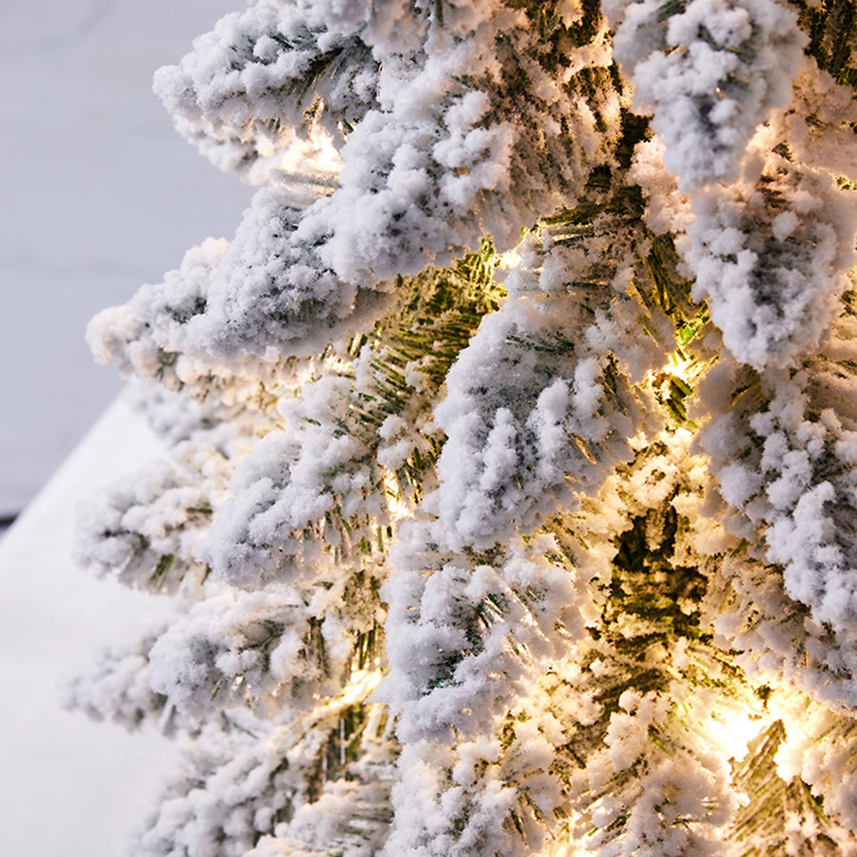 Tabletop Tree Janka – close-up of flocked branches with warm lights
