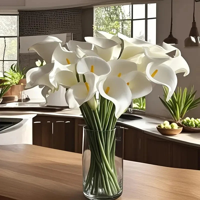 White calla lily bouquet in a tall glass vase