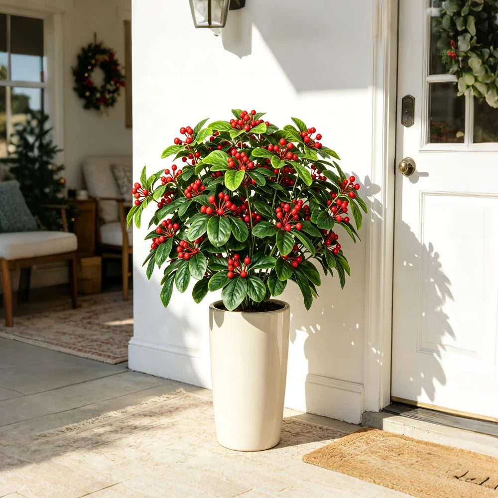 Artificial red berry plant in a planter in a bright entryway