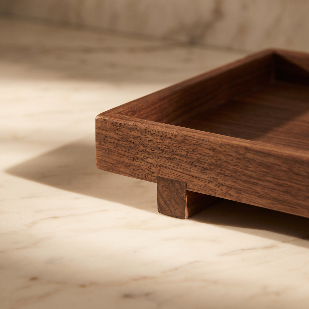 Close-up of the walnut wood grain and block foot of Bathroom Tray Žofia