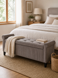 Storage Bench Renáta - warm gray upholstered storage bench at the foot of the bed