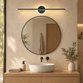 Vanity Light Erik in black above a round bathroom mirror