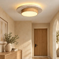 Ceiling Light Hana, a travertine and wood ceiling light glowing in a calm entryway