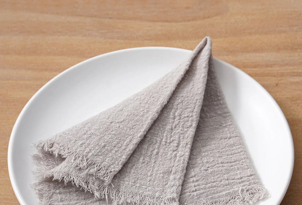 Cloth Napkins Iveta in Silver Grey folded on a plate