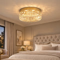 Ceiling Light Laura, a gold crystal flush-mount light in a calm bedroom