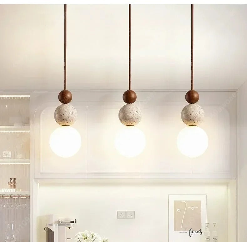Three Lenka travertine pendants hanging in a row