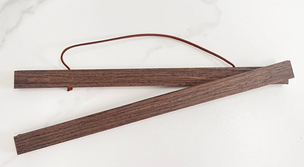 Poster hanger in walnut with leather cord