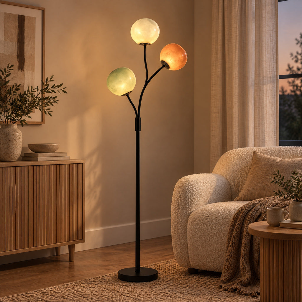 Floor Lamp Denis with three glass globes beside an armchair in a living room