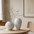 Wabi-sabi ceramic Round and Tall vases styled together on a light wood dining table with dried branches