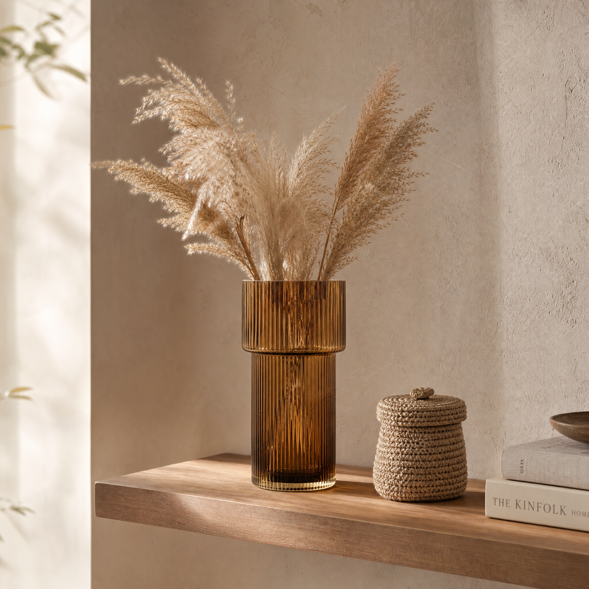 Amber ribbed glass Nora vase styled on a floating shelf with dried pampas grass and a woven basket